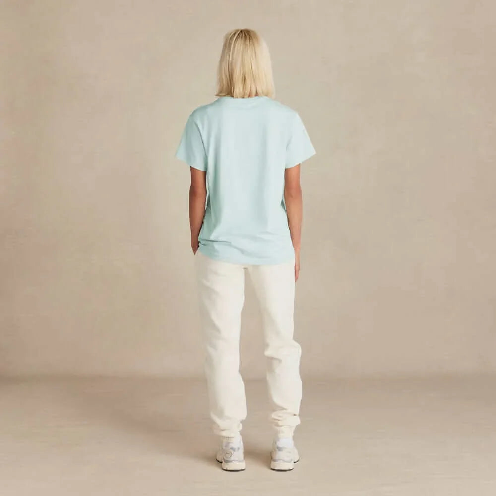 Back view of woman wearing Rose & Rae Threads organic cotton sweatpants midweight in cream with light blue t-shirt